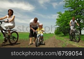 Family with children having a weekend excursion on their bikes