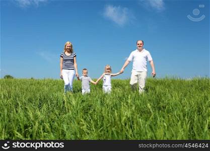 family with children in summer day on the meadow