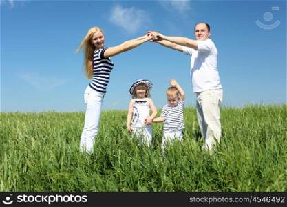 family with children in summer day on the meadow