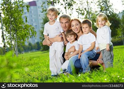 Family with four children in a summer garden