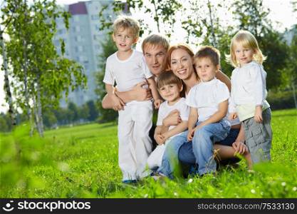 Family with four children in a summer garden