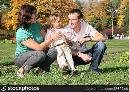 family with girl in park