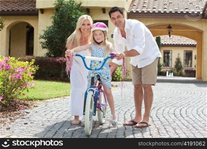 Family WIth Girl Riding Bike & Happy Parents