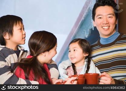 Family with hot drinks