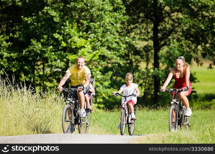family with kids riding their bicycles