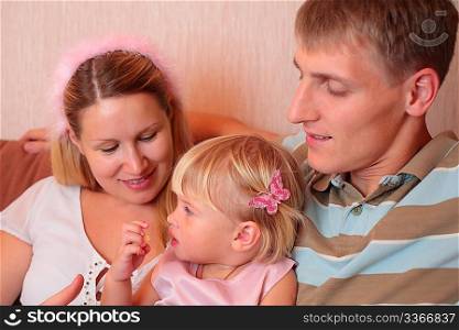 Family with little girl faces on sofa