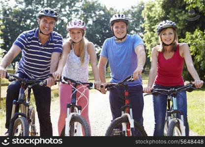 Family With Teenage Children On Cycle Ride In Countryside