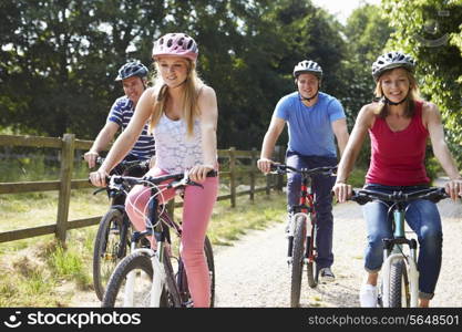 Family With Teenage Children On Cycle Ride In Countryside