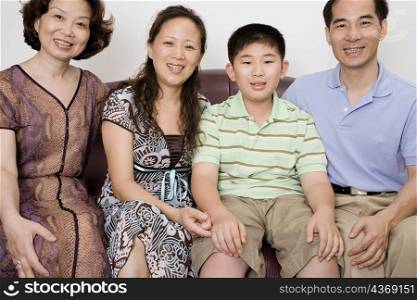 Family with their friend sitting on a couch