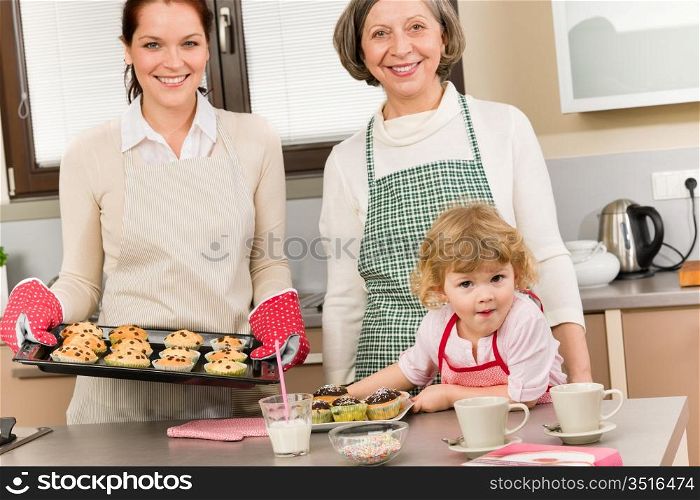 Family women baking cupcakes in kitchen grandmother, mother and granddaughter