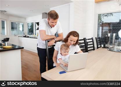 Family working on laptop together at home