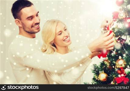 family, x-mas, winter holidays and people concept - happy couple decorating christmas tree at home. happy couple decorating christmas tree at home
