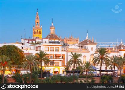 Famous Bell Tower named Giralda in landmark catholic Cathedral Saint Mary of the See during evening blue hour, Seville, Andalusia, Spain