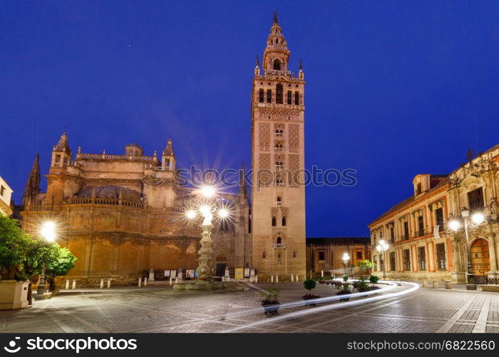 Famous Bell Tower named Giralda in landmark catholic Cathedral Saint Mary of the See at night, Seville, Andalusia, Spain
