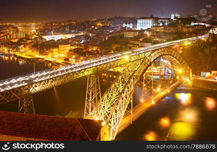 Famous Dom Luis I bridge at night. Old Town of Porto on the background. Portugal