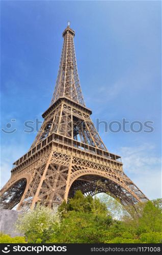 famous eiffel tower on the blue sky in Paris - France