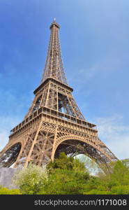 famous eiffel tower on the blue sky in Paris - France