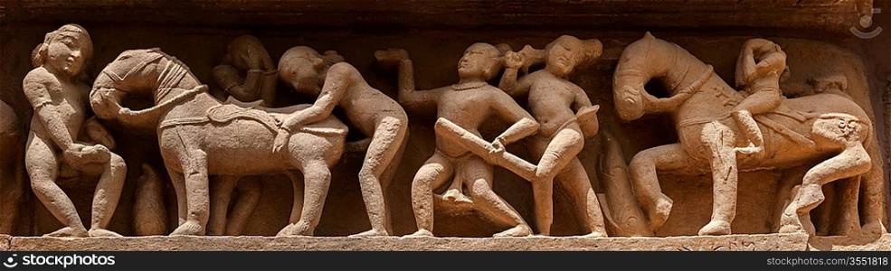 Famous erotic stone carving bas relief panorama, Lakshmana Temple, Khajuraho, India. Unesco World Heritage Site