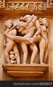 Famous erotic stone carving sculptures decorating Devi Jagadamba Temple, Khajuraho, India. Unesco World Heritage Site