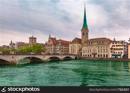 Famous Fraumunster and river Limmat on the cloudy day in Old Town of Zurich, the largest city in Switzerland. Zurich, the largest city in Switzerland