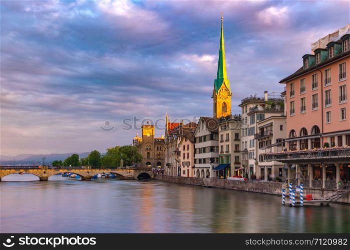 Famous Fraumunster church and river Limmat at sunrise in Old Town of Zurich, the largest city in Switzerland. Zurich, largest city in Switzerland