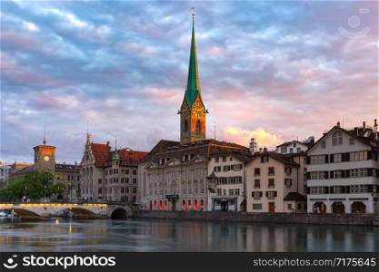 Famous Fraumunster church and river Limmat at sunrise in Old Town of Zurich, the largest city in Switzerland. Zurich, largest city in Switzerland