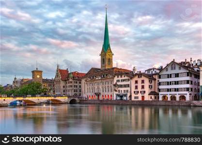 Famous Fraumunster church and river Limmat at sunrise in Old Town of Zurich, the largest city in Switzerland. Zurich, the largest city in Switzerland