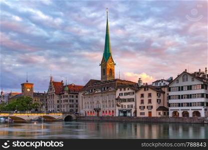 Famous Fraumunster church and river Limmat at sunrise in Old Town of Zurich, the largest city in Switzerland. Zurich, the largest city in Switzerland