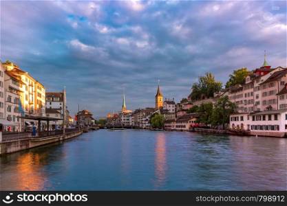 Famous Fraumunster church, Church of St Peter and river Limmat at sunset in Old Town of Zurich, the largest city in Switzerland. Zurich, the largest city in Switzerland