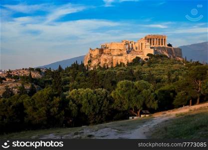 Famous greek tourist landmark - the iconic Parthenon Temple at the Acropolis of Athens as seen from Philopappos Hill on sunset. Athens, Greece. Iconic Parthenon Temple at the Acropolis of Athens, Greece