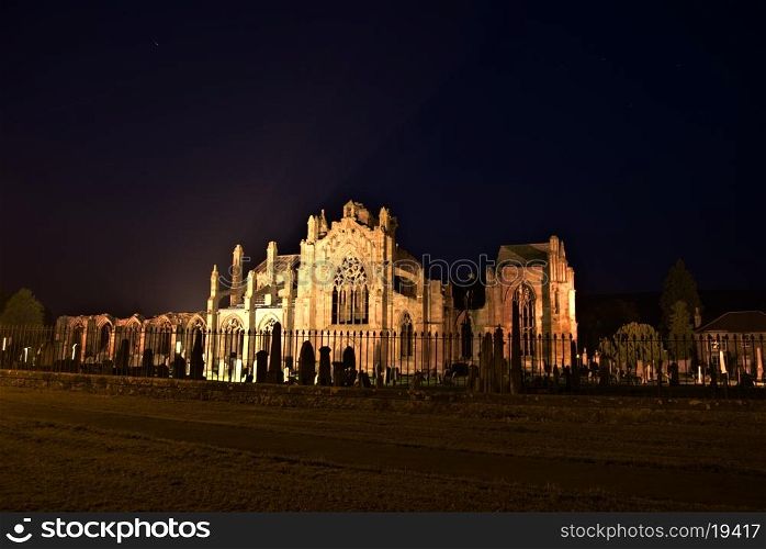 famous illuminated ruin of Melrose abbey at night