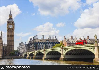 Famous landmark clock tower known as Big Ben and red london double decker bus on Westminster Bridge over the River Thames, London, England