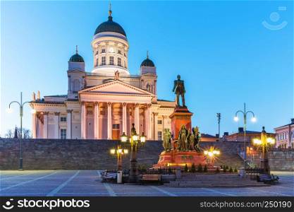 Famous landmark in Finnish capital: scenic evening summer view of Senate Square with Lutheran cathedral and monument to Russian Emperor Alexander II in the Old Town of Helsinki, Finland