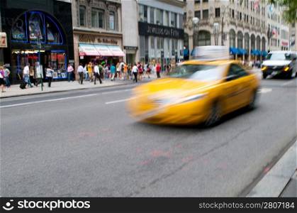 Famous New York yellow taxi cabs in motion - intentional blur