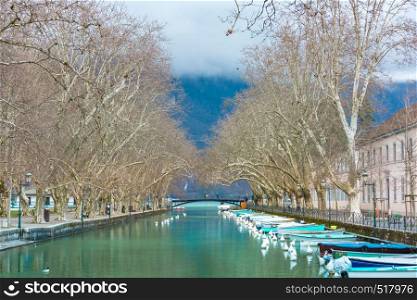 Famous pedestrian footbridge Bridge of Loves or Pont des Amours over channel of Vasse near lake of Annecy, Venice of the Alps, France. Pont des Amours in Annecy, France