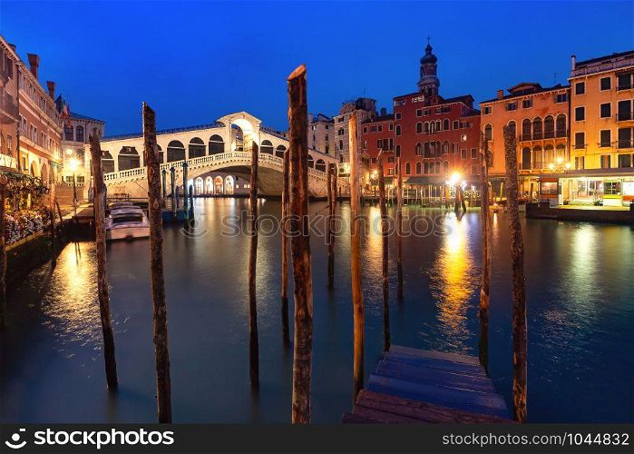 Famous Rialto Bridge or Ponte di Rialto over the Grand Canal in Venice during evening blue hour, Italy.. The Rialto Bridge, Venice, Italy