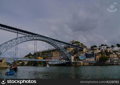 Famous steel bridge Ponte dom Luis above connects Old town Porto with Vila Nova de Gaia at river Duoro, Portugal