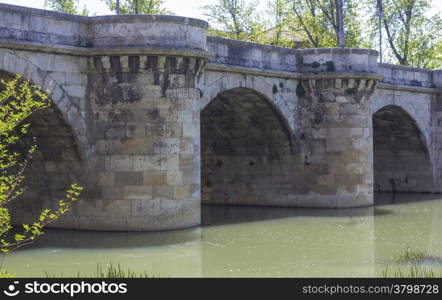 famous stone bridge, Puente Mayor, XVI Century, in Palencia, Spain