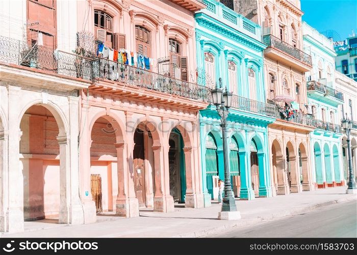 Famous street in old Havana with old buildings and cars. Authentic view of a street of Old Havana with old buildings and cars