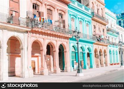 Famous street in old Havana with old buildings and cars. Authentic view of a street of Old Havana with old buildings and cars