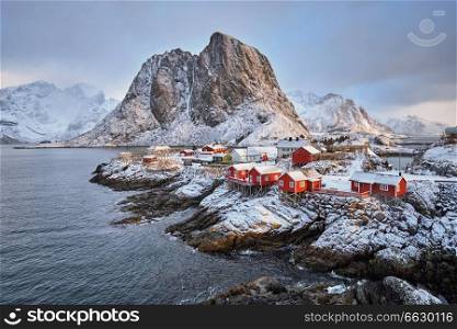Famous tourist attraction Hamnoy fishing village on Lofoten Islands, Norway with red rorbu houses in winter. Hamnoy fishing village on Lofoten Islands, Norway 