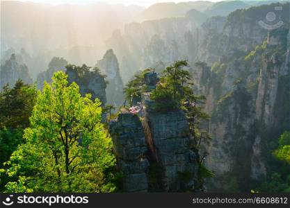 Famous tourist attraction of China - Zhangjiajie stone pillars cliff mountains on sunset at Wulingyuan, Hunan, China. Zhangjiajie mountains, China