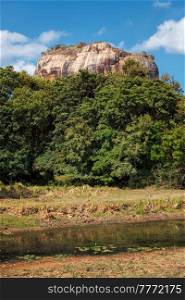 Famous tourist landmark of Sri Lanka - ancient Sigiriya rock (Lion rock) with palace fortress ruins on top in Sigiriya, Sri Lanka. UNESCO World Heritage Site. Famous tourist landmark - ancient Sigiriya rock, Sri Lanka
