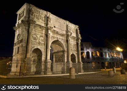 famous triumphal arch standing next to the colosseum in Rome at night