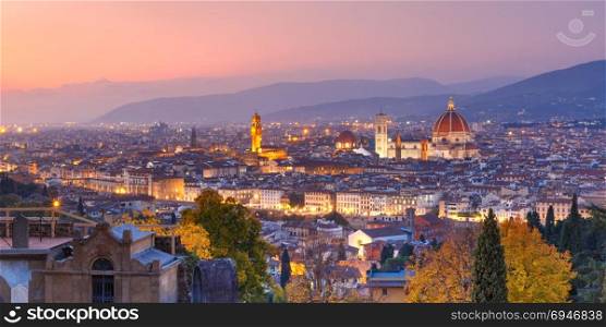 Famous view of Florence at night, Italy. Beautiful panoramic view of Duomo Santa Maria Del Fiore and tower of Palazzo Vecchio during evening blue hour in Florence, Tuscany, Italy