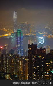 Famous view of Hong Kong - Hong Kong skyscrapers skyline cityscape view from Victoria Peak illuminated in the evening blue hour. Hong Kong, China. Hong Kong skyscrapers skyline cityscape view