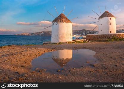 Famous view, Traditional windmills on the island Mykonos, The island of the winds, at sunrise, Greece. Traditional windmills at sunrise, Santorini, Greece