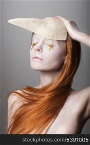 Fanatsy. Stylized Woman with Golden Teardrops holding Carnival Mask