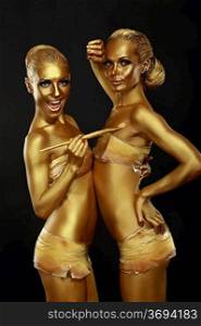 Fancy Dress Party. Couple of Women with Golden Metallic Painted Skin. Creativity
