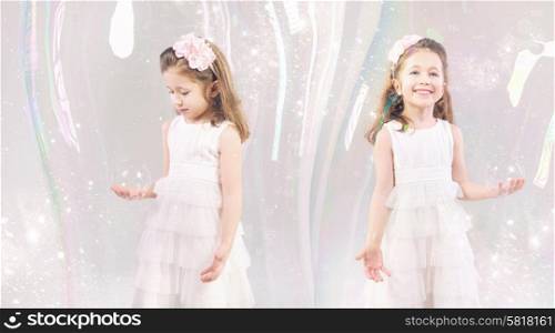 Fancy picture of little girls closed in large soap bubbles